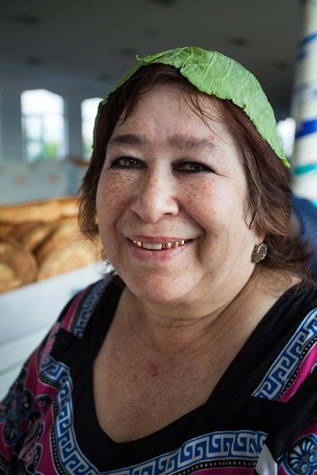 vendor putting a cabbage leaf on her head